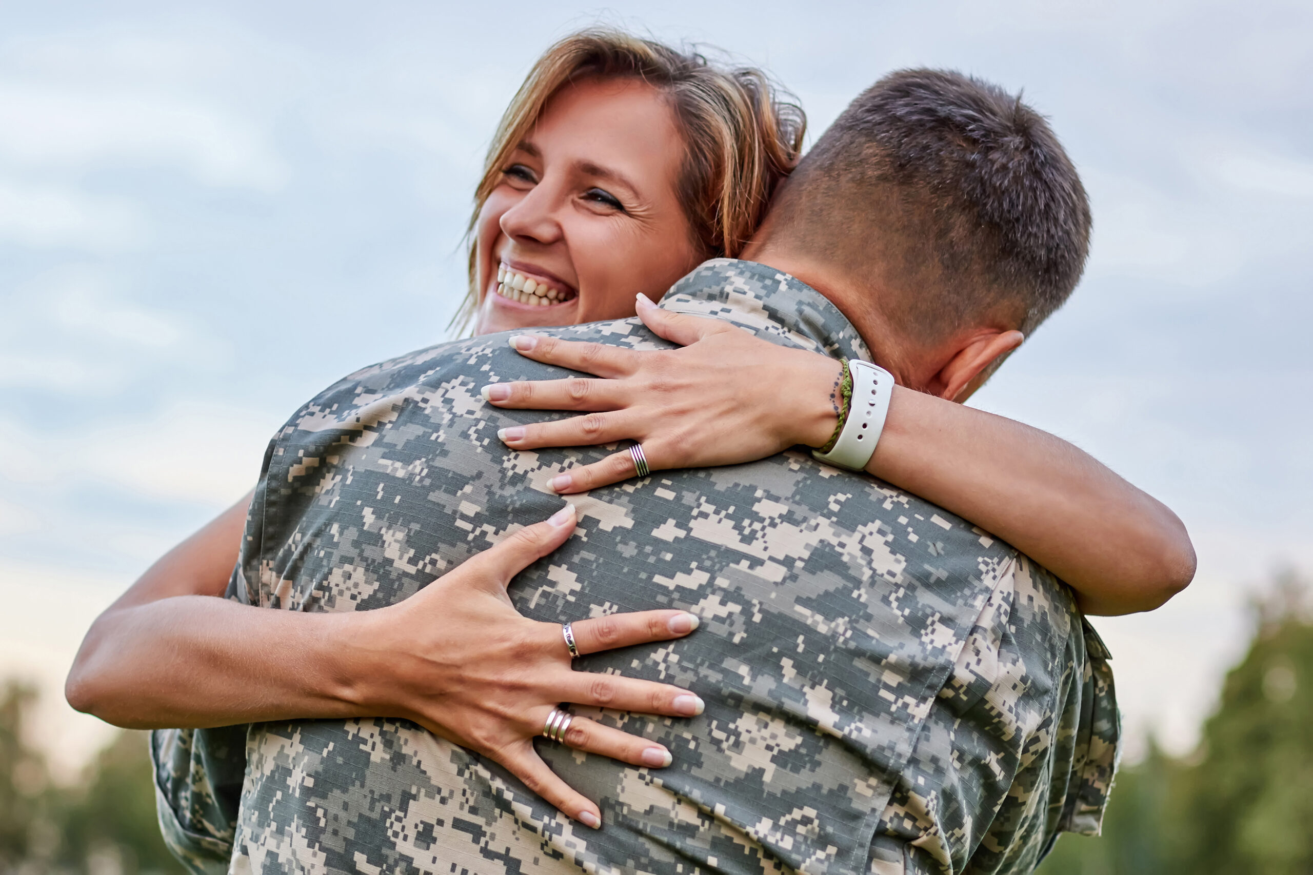 Happy woman hugging his husband came back from army.